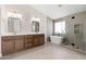 A luxurious bathroom showcases a dual vanity, soaking tub, and glass shower with a rain shower head at 4216 E Tether Trl, Phoenix, AZ 85050