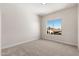 Bedroom with neutral carpet and paint and a window overlooking the neighborhood at 4216 E Tether Trl, Phoenix, AZ 85050