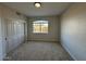 Bedroom featuring neutral walls and carpet, with a large window and closet at 4216 E Tether Trl, Phoenix, AZ 85050