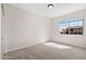 Bright bedroom features neutral carpet and paint, and a window with a grid design at 4216 E Tether Trl, Phoenix, AZ 85050