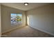 Bedroom featuring neutral walls and carpet, with natural light and views of the neighborhood at 4216 E Tether Trl, Phoenix, AZ 85050