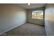 Neutral bedroom offers carpet and an arched window view to the outdoors at 4216 E Tether Trl, Phoenix, AZ 85050