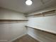 Walk-in closet featuring multiple rows of wood shelving and carpeted floors at 4216 E Tether Trl, Phoenix, AZ 85050