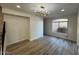 Spacious dining room with wood-look tile floors, a modern chandelier, and large window at 4216 E Tether Trl, Phoenix, AZ 85050