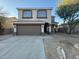 Exterior view of the home showing a large front yard and two car garage at 4216 E Tether Trl, Phoenix, AZ 85050