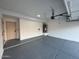 View of the well-lit two car garage with epoxy flooring and a wall-mounted water heater at 4216 E Tether Trl, Phoenix, AZ 85050