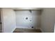 Empty laundry room includes wood look flooring, shelf and outlets at 4216 E Tether Trl, Phoenix, AZ 85050