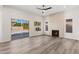 Modern living room featuring a fireplace, wood-style floors, and sliding glass doors for natural light and backyard access at 4216 E Tether Trl, Phoenix, AZ 85050