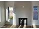 Bright living room featuring a modern fireplace with tile surround and wood-look floors at 4216 E Tether Trl, Phoenix, AZ 85050