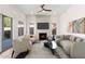 Cozy living room with a fireplace, plush seating, and a ceiling fan creating a comfortable and inviting atmosphere at 4216 E Tether Trl, Phoenix, AZ 85050