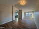 Spacious living room featuring wood-look tile flooring and archway to bathroom at 4216 E Tether Trl, Phoenix, AZ 85050