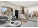 Bright living room with a modern chandelier, stylish furniture, and large windows that bring in natural light at 4216 E Tether Trl, Phoenix, AZ 85050