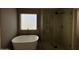 Modern bathroom with a soaking tub, walk-in shower, and tiled walls at 4216 E Tether Trl, Phoenix, AZ 85050