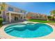 Inviting backyard pool and spa, perfect for relaxation with a covered patio and lush landscaping in the background at 4216 E Tether Trl, Phoenix, AZ 85050