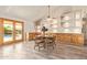 Charming dining area with a round table, oak cabinets, and French doors that lead to the pool and backyard at 4409 E Gelding Dr, Phoenix, AZ 85032