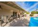 Covered patio with ceiling fans and outdoor seating beside a sparkling pool, excellent for entertaining or relaxing outdoors at 4409 E Gelding Dr, Phoenix, AZ 85032