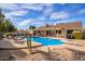 Spacious backyard featuring a large pool, patio area, and lush greenery at 4409 E Gelding Dr, Phoenix, AZ 85032