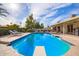 Backyard featuring a refreshing pool, lounge chairs, and a diving board at 4409 E Gelding Dr, Phoenix, AZ 85032