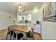 Dining area with a modern light fixture and a view into the kitchen at 4620 N 68Th St # 111, Scottsdale, AZ 85251