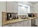 Stylish kitchen with white cabinets, granite countertops, and modern appliances at 4620 N 68Th St # 111, Scottsdale, AZ 85251