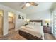 This main bedroom offers a king bed, ceiling fan, and ensuite bathroom at 4620 N 68Th St # 111, Scottsdale, AZ 85251