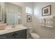 Bathroom with grey vanity, and decorative towels hanging near sink and toilet at 6451 N 17Th Pl, Phoenix, AZ 85016