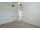 Spacious bedroom with neutral carpet, ceiling fan, and an open doorway at 6451 N 17Th Pl, Phoenix, AZ 85016