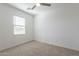 Bright bedroom with neutral carpet, ceiling fan, and a window with blinds for natural light at 6451 N 17Th Pl, Phoenix, AZ 85016