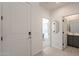 Bright entryway with a white door, light wood floors, and views into a bathroom and study at 6451 N 17Th Pl, Phoenix, AZ 85016