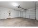 Spacious garage with concrete floor, a water heater, and a large garage door at 6451 N 17Th Pl, Phoenix, AZ 85016