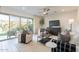 Bright living room with neutral furniture, a ceiling fan, and sliding glass doors to the backyard at 6451 N 17Th Pl, Phoenix, AZ 85016