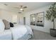 Bright main bedroom featuring a ceiling fan, mirrors, and access to the bathroom at 6451 N 17Th Pl, Phoenix, AZ 85016