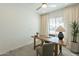 A sunlit office with a ceiling fan, natural light and a wooden desk offers a quiet workspace at 6451 N 17Th Pl, Phoenix, AZ 85016