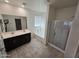 A spacious primary bathroom with double vanity, soaking tub, and glass shower at 7321 N 123Rd Dr, Glendale, AZ 85307