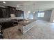 Spacious kitchen featuring granite countertops, an island with a sink, and dark wood cabinetry at 7321 N 123Rd Dr, Glendale, AZ 85307