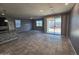 Open-concept living room with tile flooring, recessed lighting, and sliding glass doors to the backyard at 7321 N 123Rd Dr, Glendale, AZ 85307