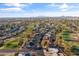 Wide aerial view of a community near a golf course, showcasing mature trees and distant mountains at 734 S Edgewater Dr, Mesa, AZ 85208