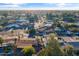 Expansive aerial view of a residential neighborhood with tree-lined streets on a bright sunny day at 734 S Edgewater Dr, Mesa, AZ 85208