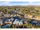 Scenic aerial view of a suburban neighborhood featuring a pool, mature trees, and mountain views at 734 S Edgewater Dr, Mesa, AZ 85208