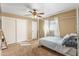 Carpeted bedroom with a ceiling fan, large closet with sliding doors and light walls at 734 S Edgewater Dr, Mesa, AZ 85208