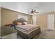 Carpeted bedroom with a ceiling fan, a queen bed and neutral walls at 734 S Edgewater Dr, Mesa, AZ 85208