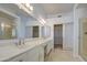 Bathroom featuring double sinks, a walk-in closet, and a glass-enclosed shower at 792 W Nolan Way, Chandler, AZ 85248