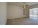 Neutral bedroom with a ceiling fan and sliding glass door to the outdoor area at 792 W Nolan Way, Chandler, AZ 85248