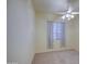 Bedroom with a ceiling fan, neutral carpet, and window dressed with patterned curtains at 792 W Nolan Way, Chandler, AZ 85248