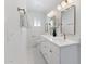 Elegant bathroom featuring double sinks, white cabinetry, gold fixtures, and marble tile flooring at 800 W Erie St, Chandler, AZ 85225