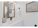 Charming half bathroom with white vanity, marble countertop, and stylish mirror at 800 W Erie St, Chandler, AZ 85225