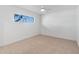 Bright bedroom featuring neutral carpet, a ceiling fan, and a window providing natural light at 800 W Erie St, Chandler, AZ 85225