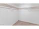 Spacious walk-in closet with white shelving and wooden rods for ample storage at 800 W Erie St, Chandler, AZ 85225