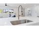 Close-up of the kitchen sink featuring stainless steel faucet and modern white countertop at 800 W Erie St, Chandler, AZ 85225