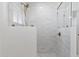 Luxurious bathroom shower featuring white tiles, a glass door, and modern fixtures at 800 W Erie St, Chandler, AZ 85225